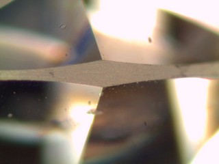 A bruted diamond girdle refers to the technique used in the finishing process of a diamond, specifically around the diamond's outer edge, known as the girdle.