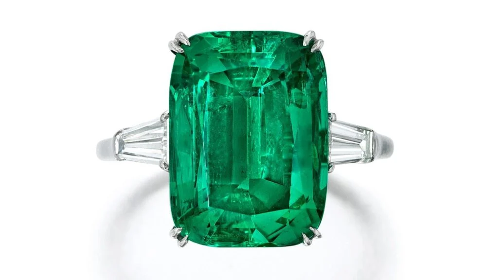 A Harry Winston ring centering a cushion-cut, 7.08-carat Colombian emerald